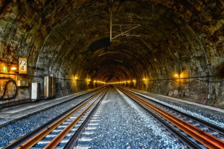 railway tunnel showing tracks disappearing into the distance