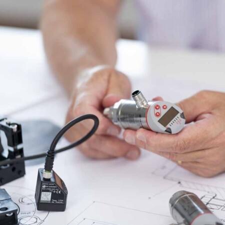 male hands examining a pneumatic pressure switch