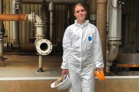 DuPont Tyvek 500 Xpert hooded coverall being worn in an industrial setting