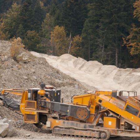 yellow heavy vehicle in quarry setting